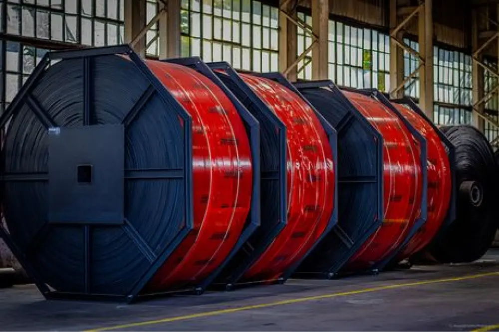 Three red steel coils in industrial building
